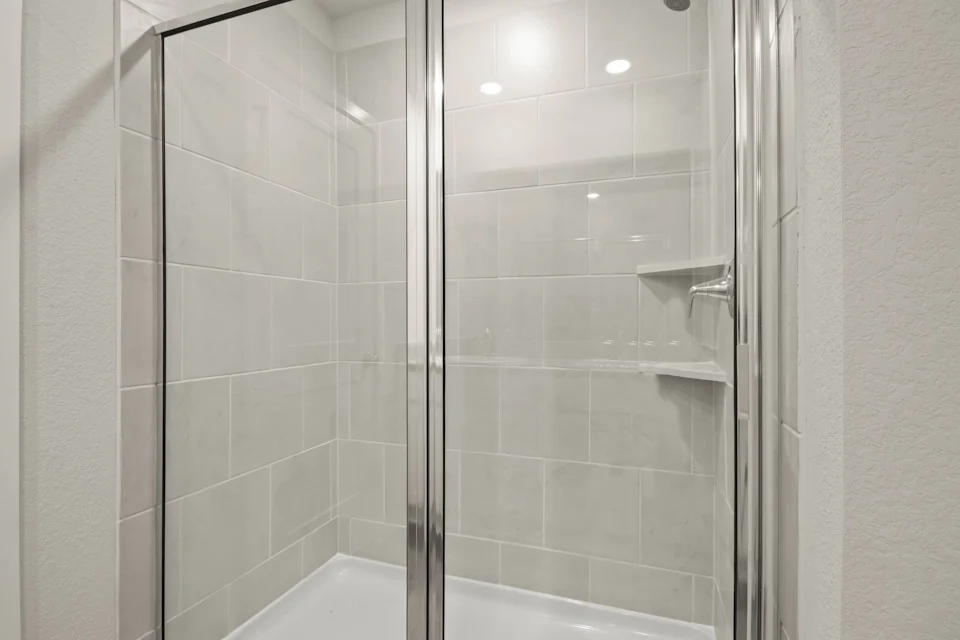 A shower with a glass door.