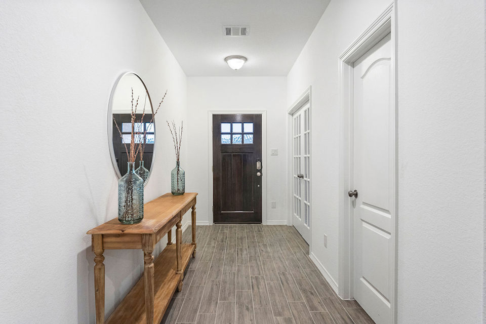 A room with a table and a mirror.