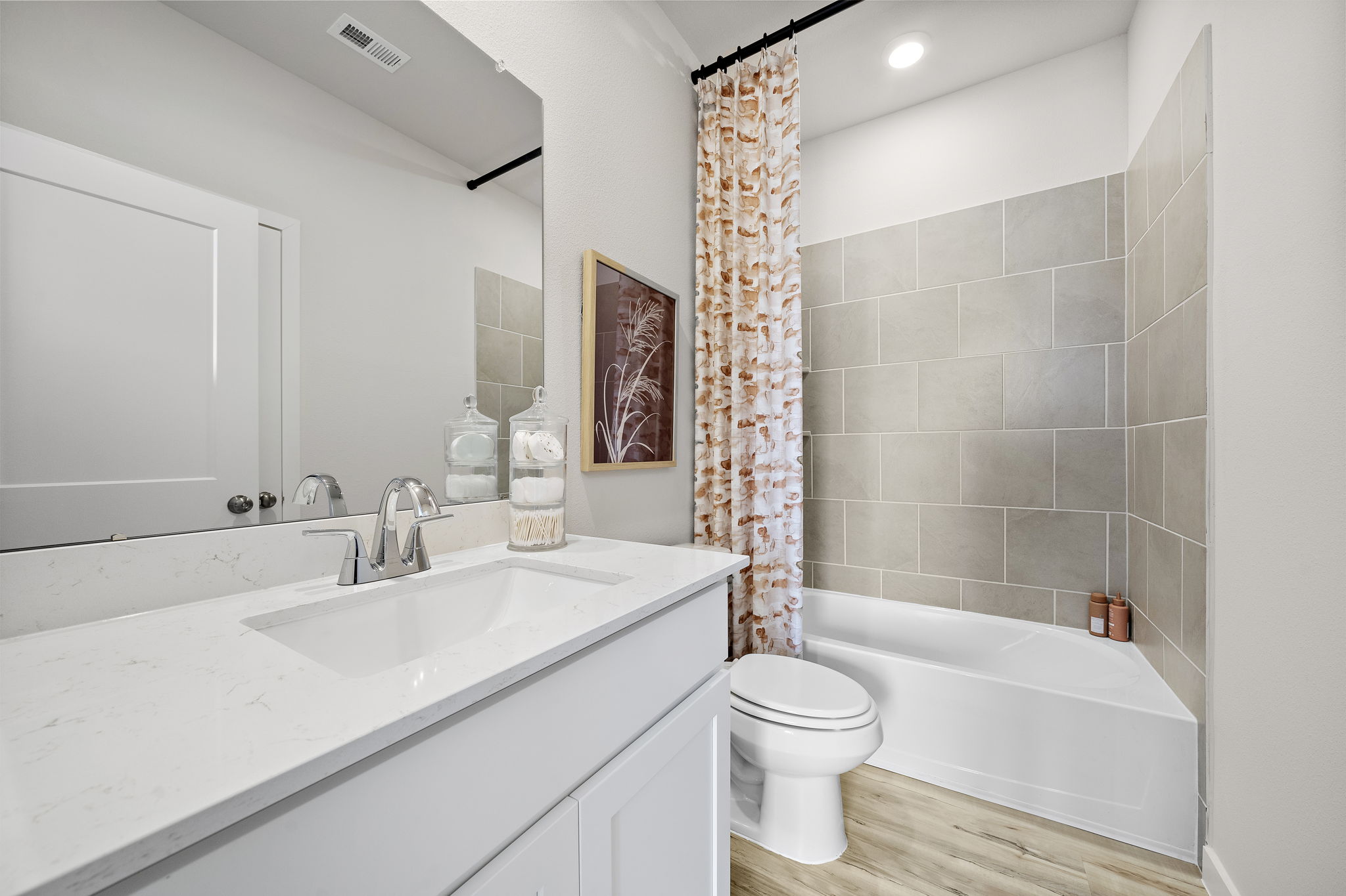 A bathroom with a tub toilet and sink.