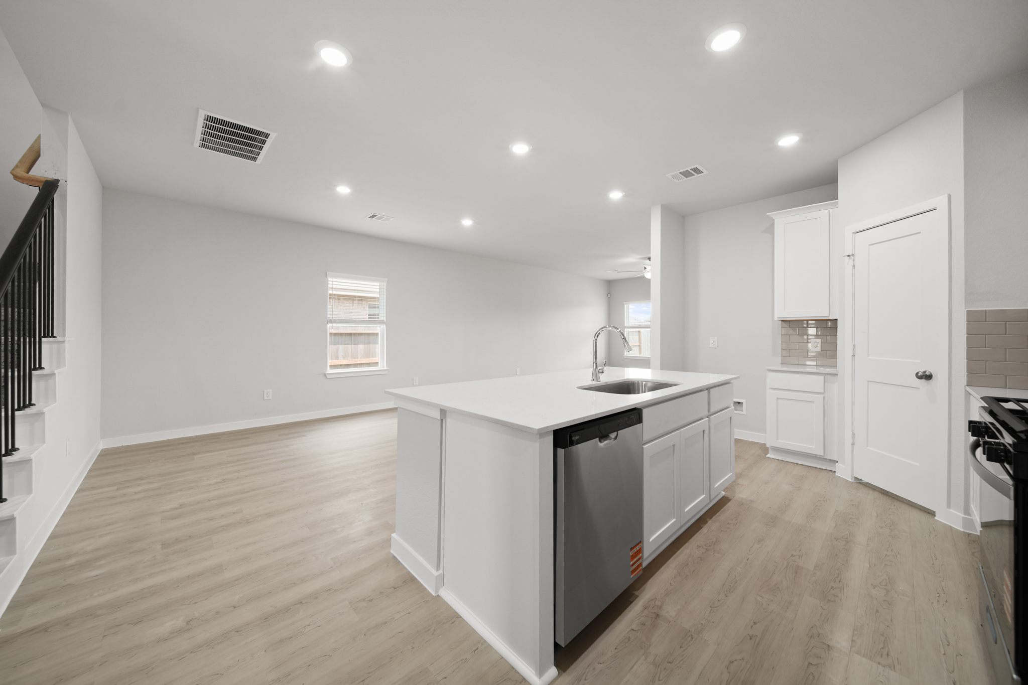 A kitchen with white cabinets.