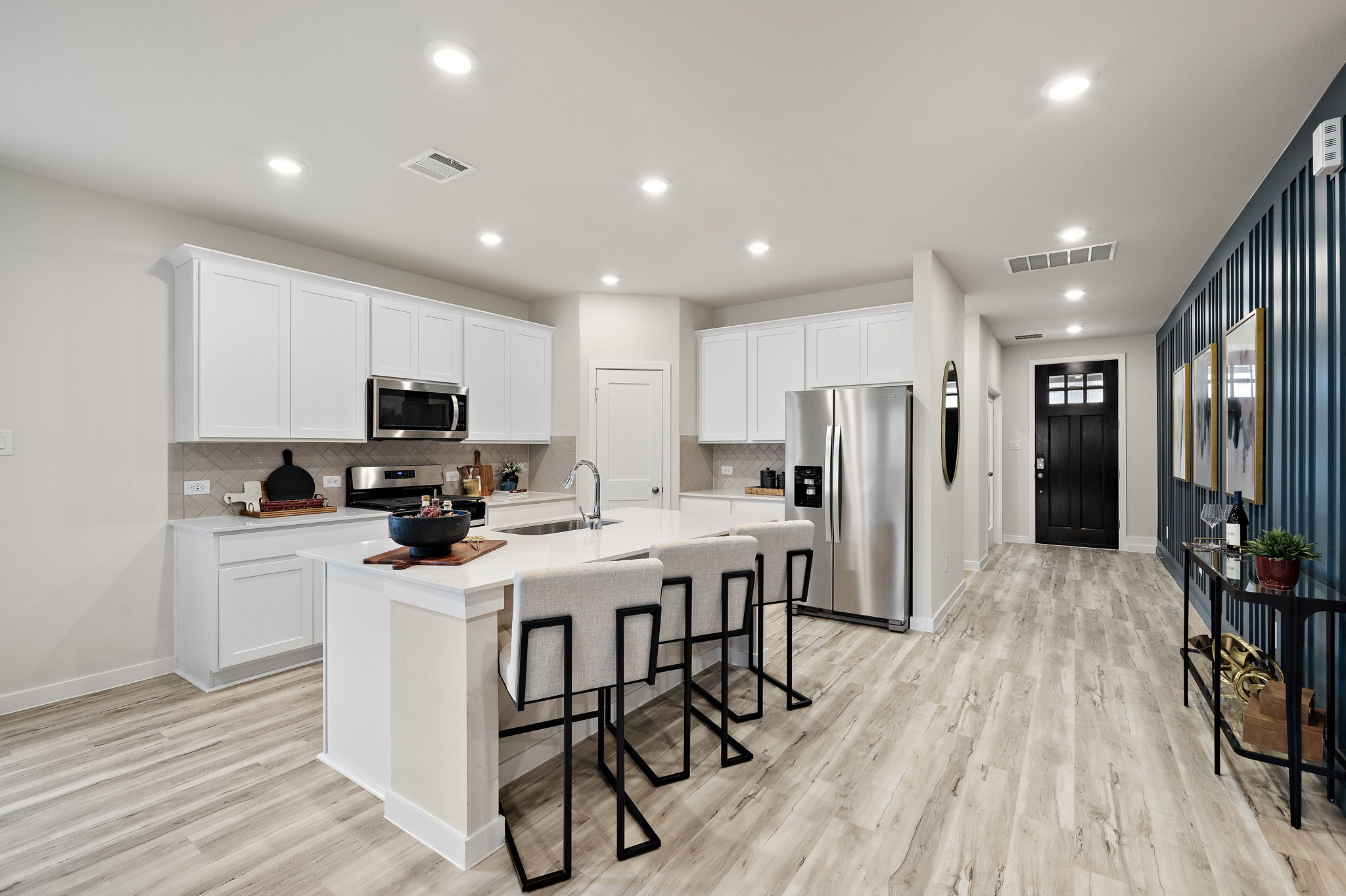 A kitchen with white cabinets.