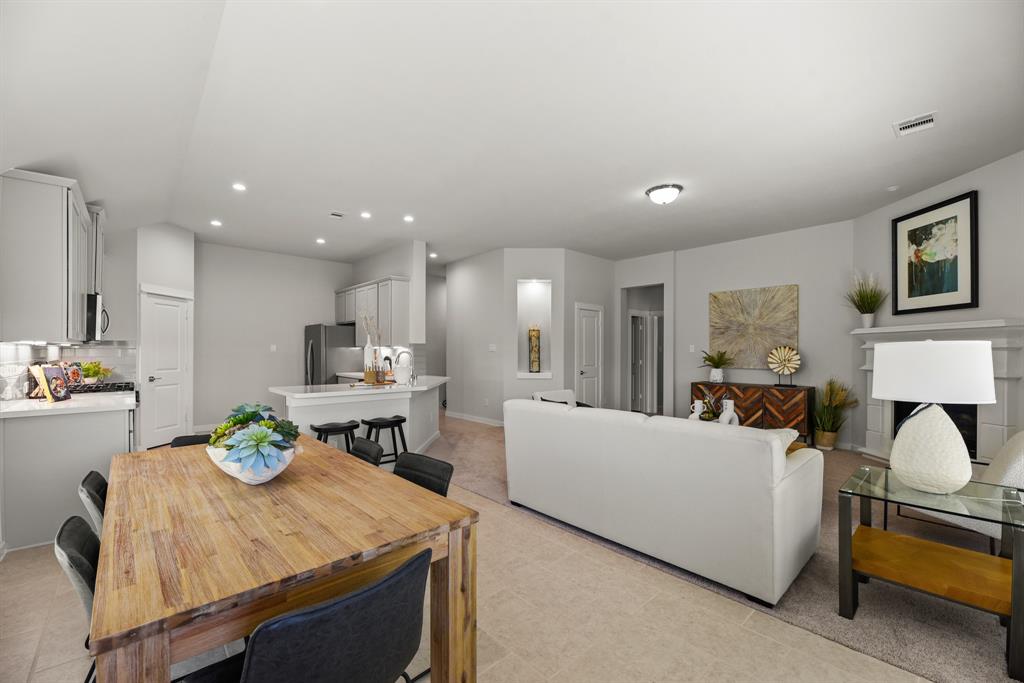 A large living room with a dining table and couches.