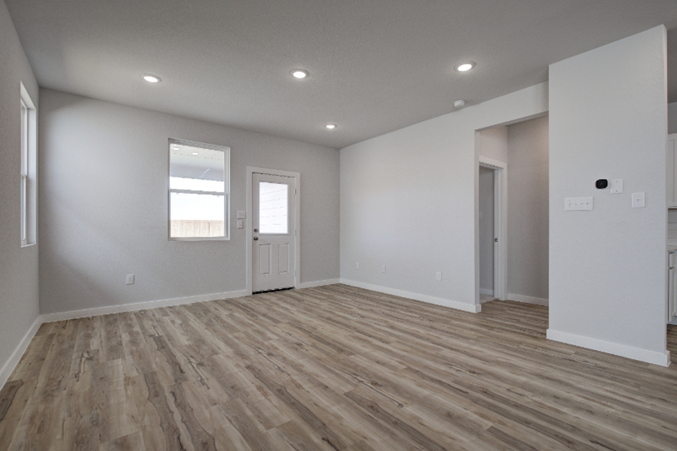 A room with white walls and a wood floor.