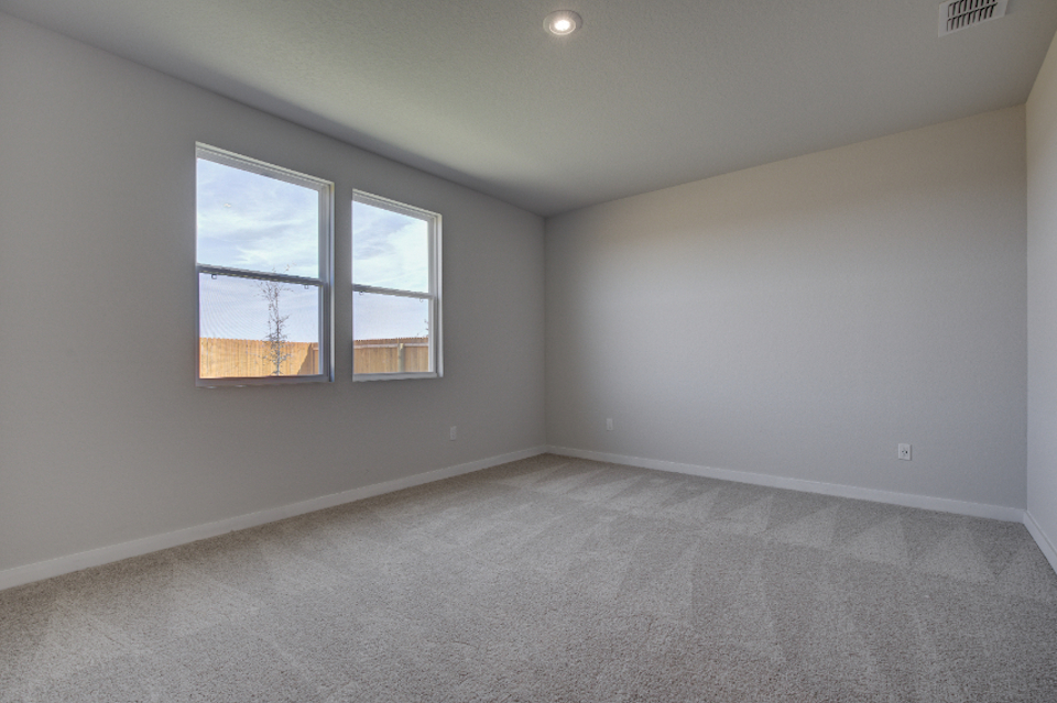 A room with a window and a carpet.