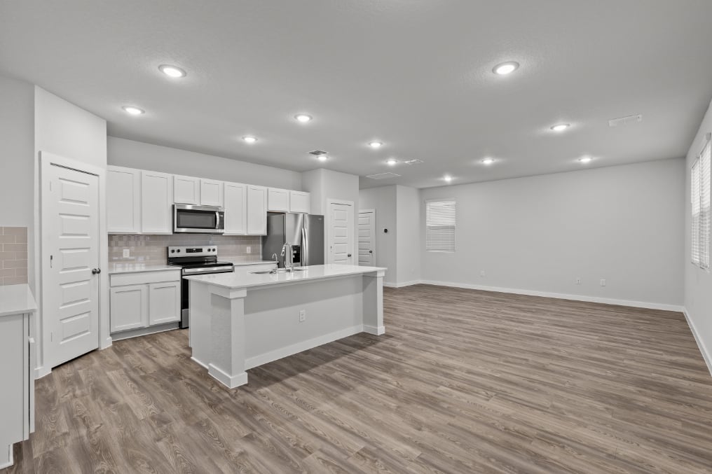A kitchen with white cabinets.