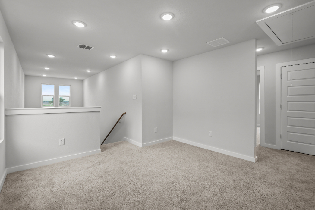 A room with white walls and a ladder.