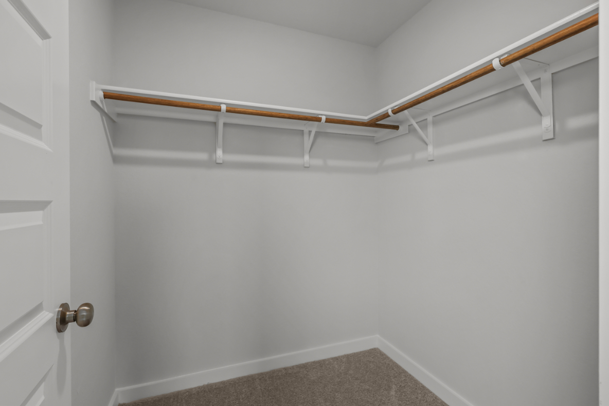 A white wall with a metal railing.