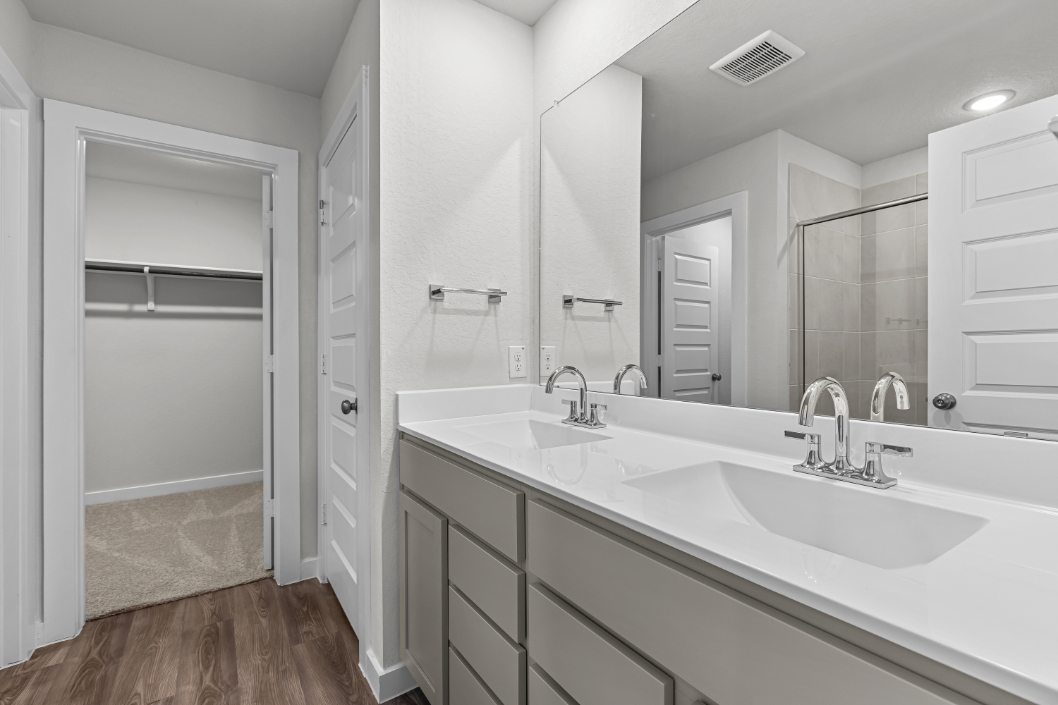 A bathroom with a large mirror.