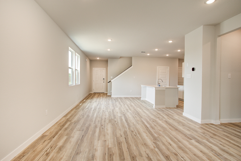 A room with white walls and a wood floor.