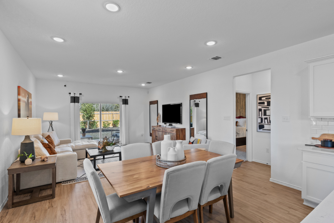 A dining room with a large table.