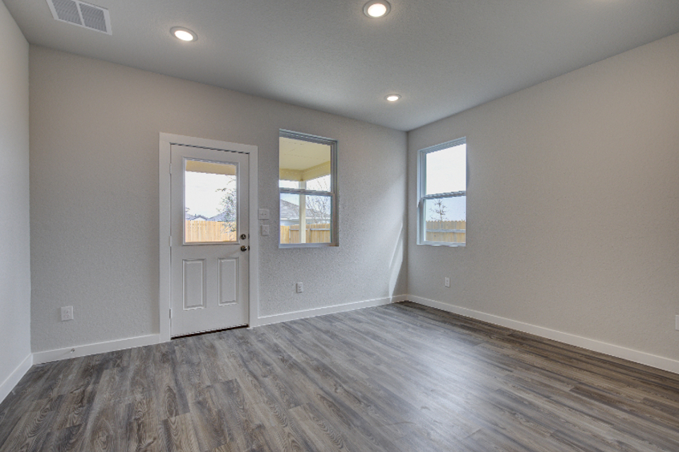 A room with a wood floor and white doors.