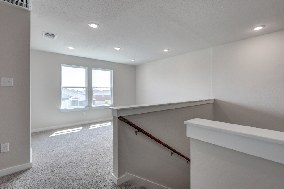 A room with a staircase and a window.