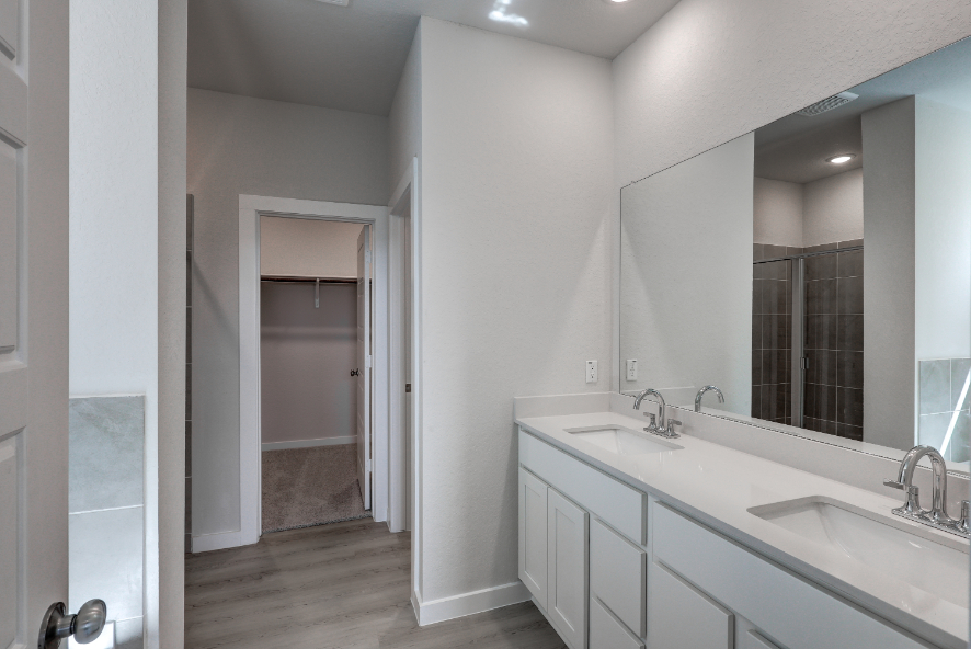 A bathroom with a large mirror.