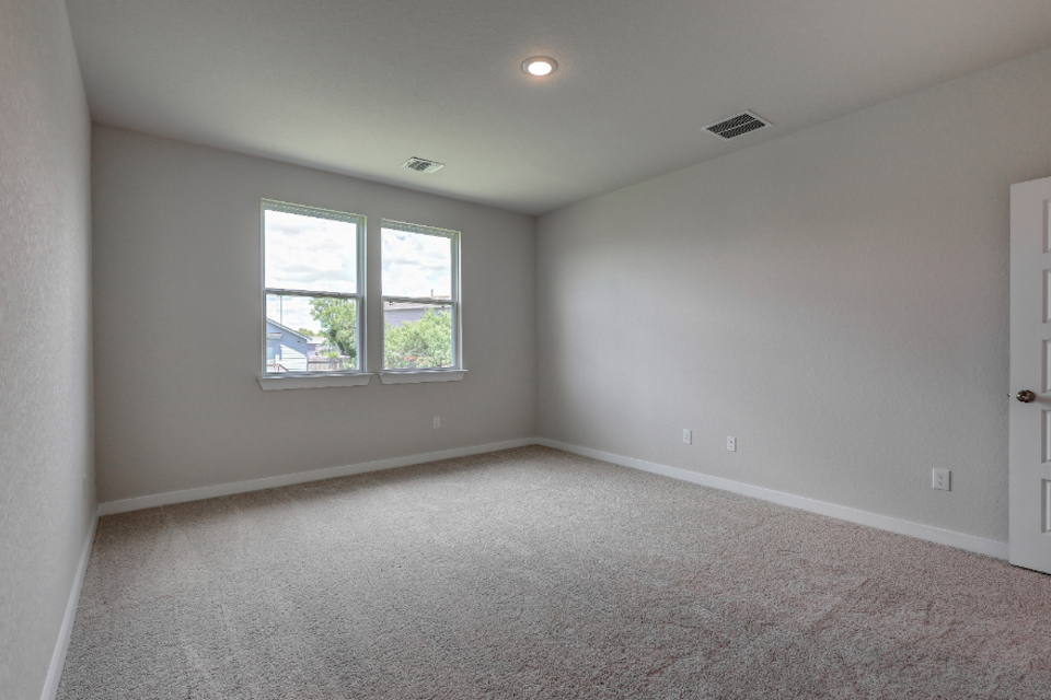 A room with a window and carpet.