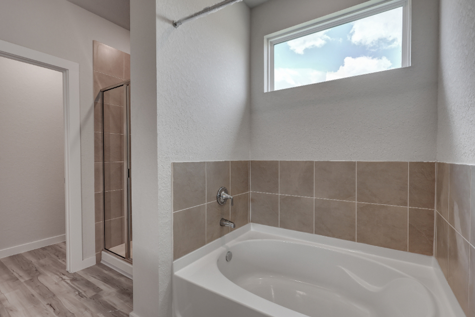 A bathroom with a bathtub and shower.