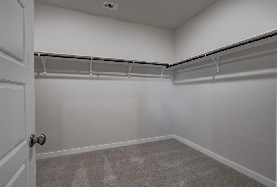 A white room with a metal railing.