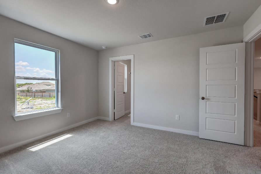 A room with white walls and a window.