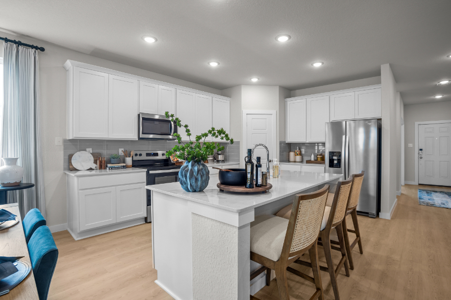 A kitchen with white cabinets.