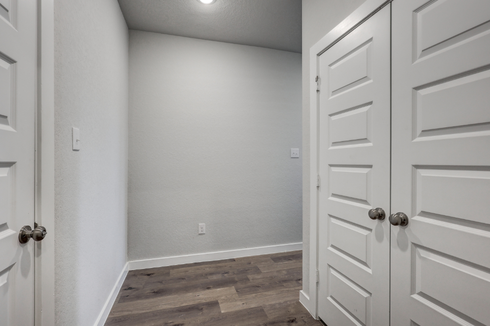 A room with white cabinets.