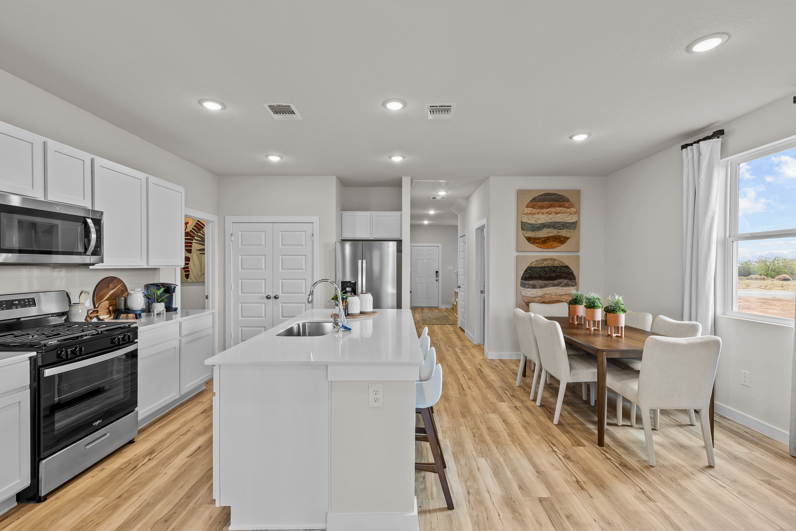A kitchen with white cabinets.