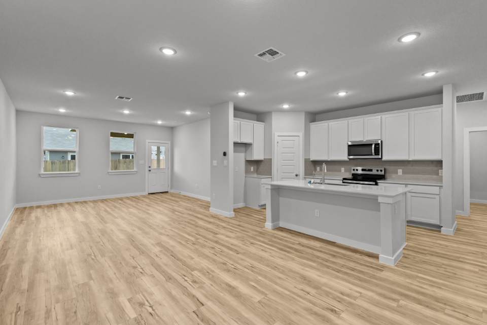 A large kitchen with white cabinets.