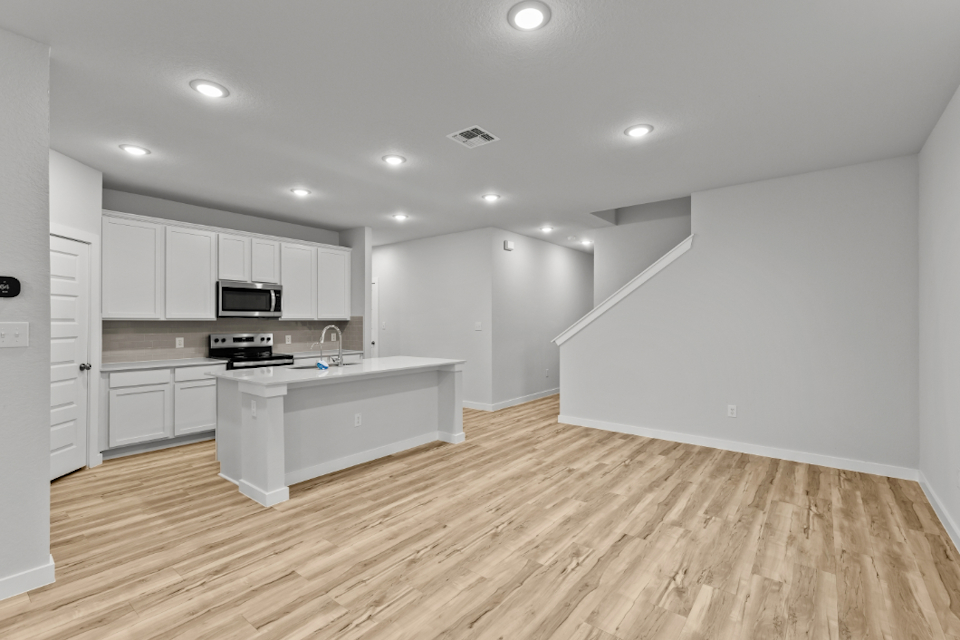 A kitchen with white cabinets.