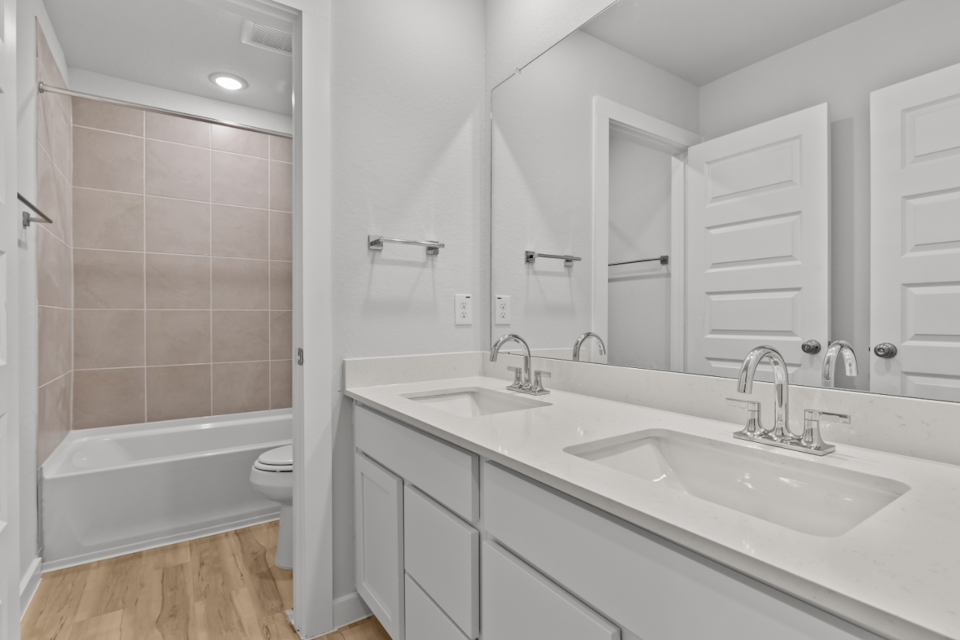 A bathroom with a tub sink and toilet.