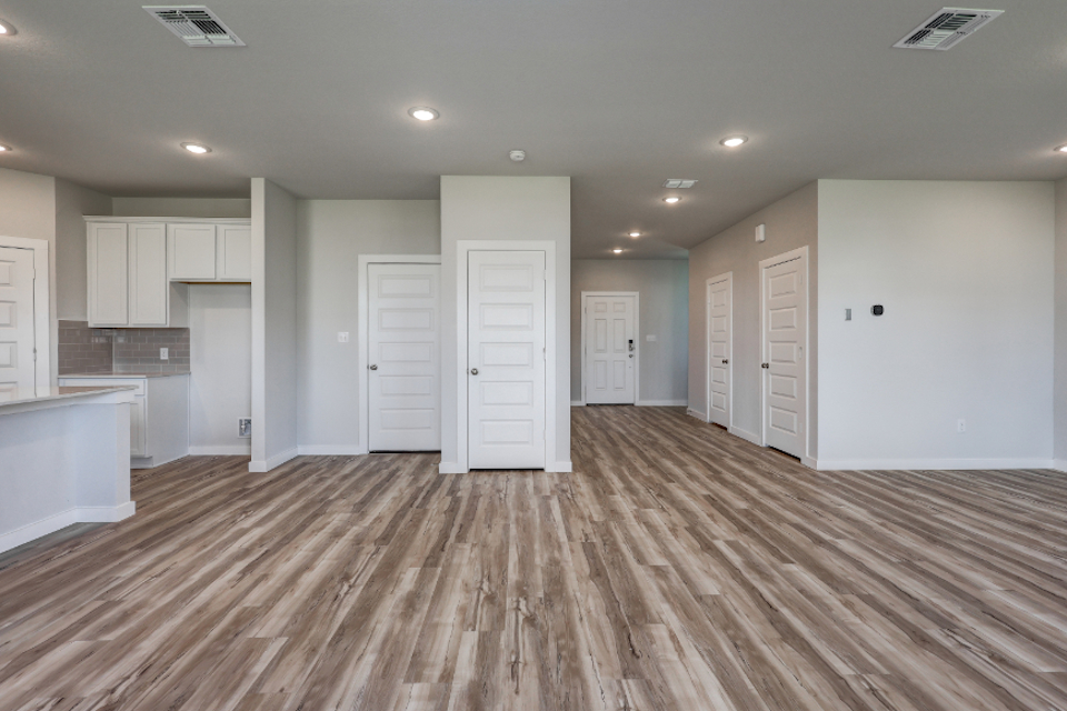 A large empty room with white doors.