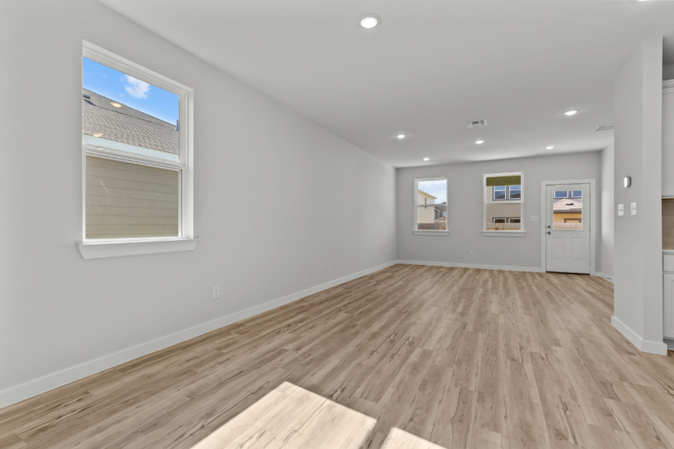 A room with a wood floor and white walls.