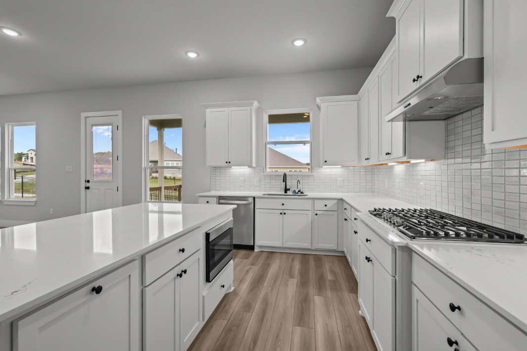 A kitchen with white cabinets.