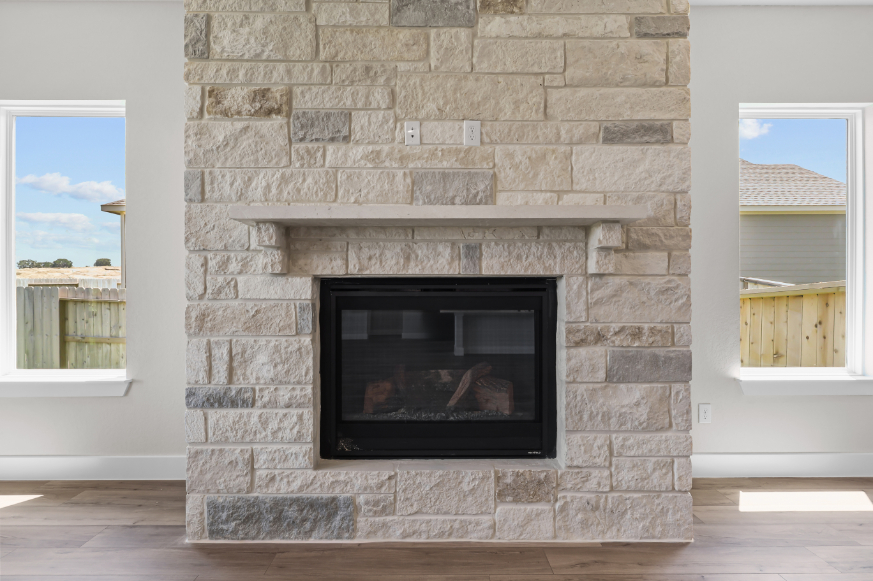 A fireplace in a stone building.