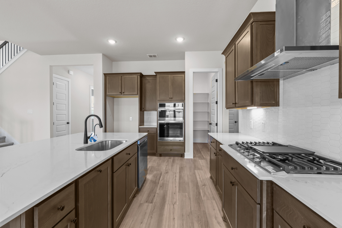 A kitchen with wooden cabinets.