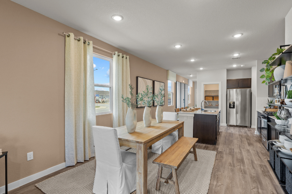 A kitchen with a dining table.