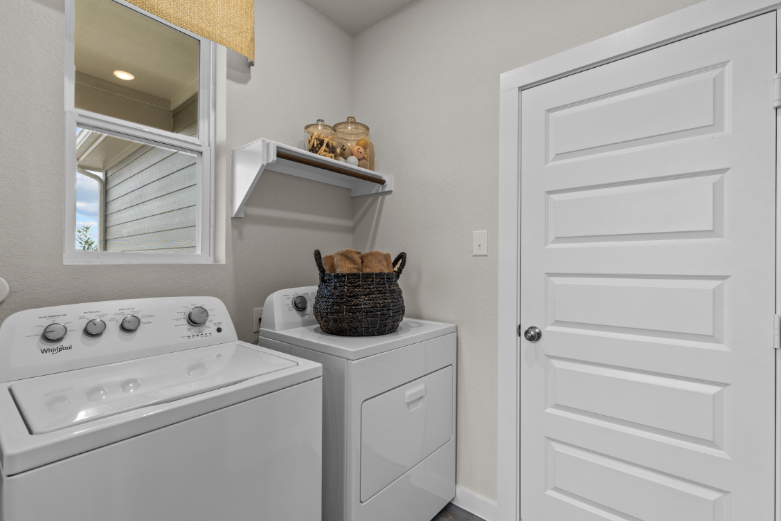 A white kitchen with a white cabinet and a white counter top.