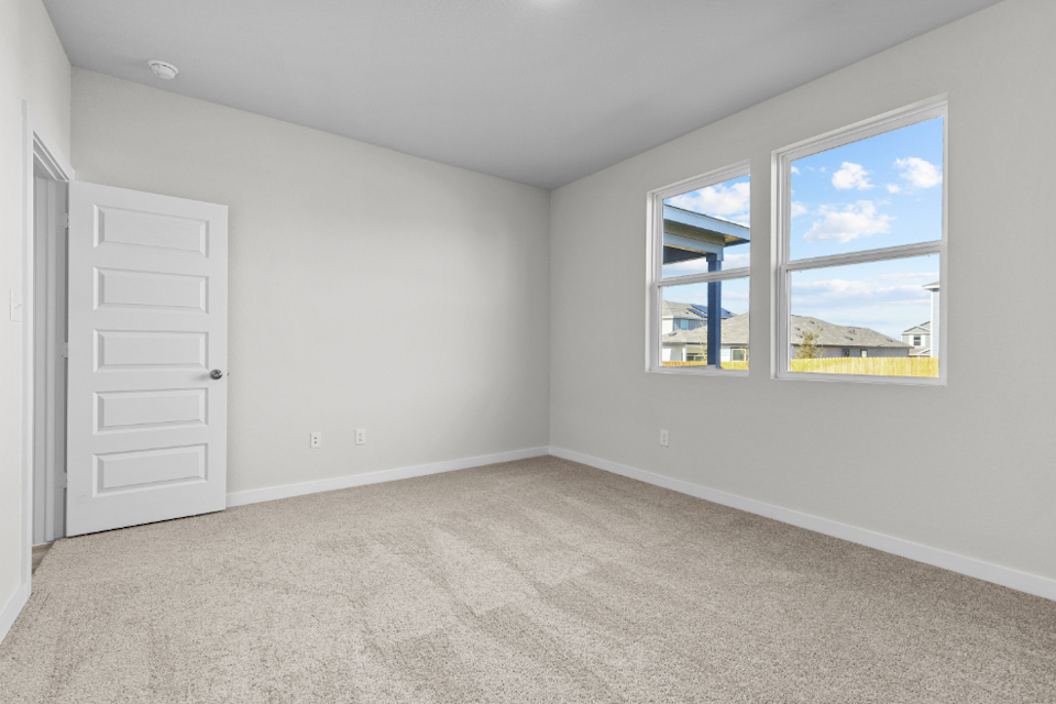 A room with a window and a door.