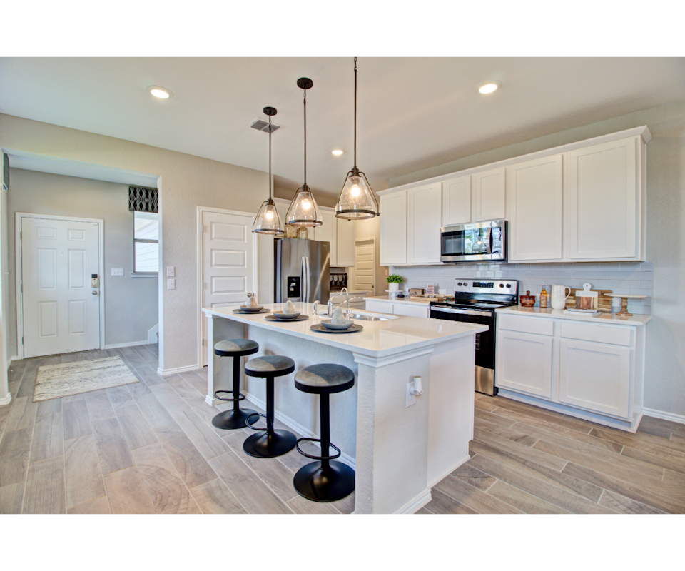 A kitchen with white cabinets.
