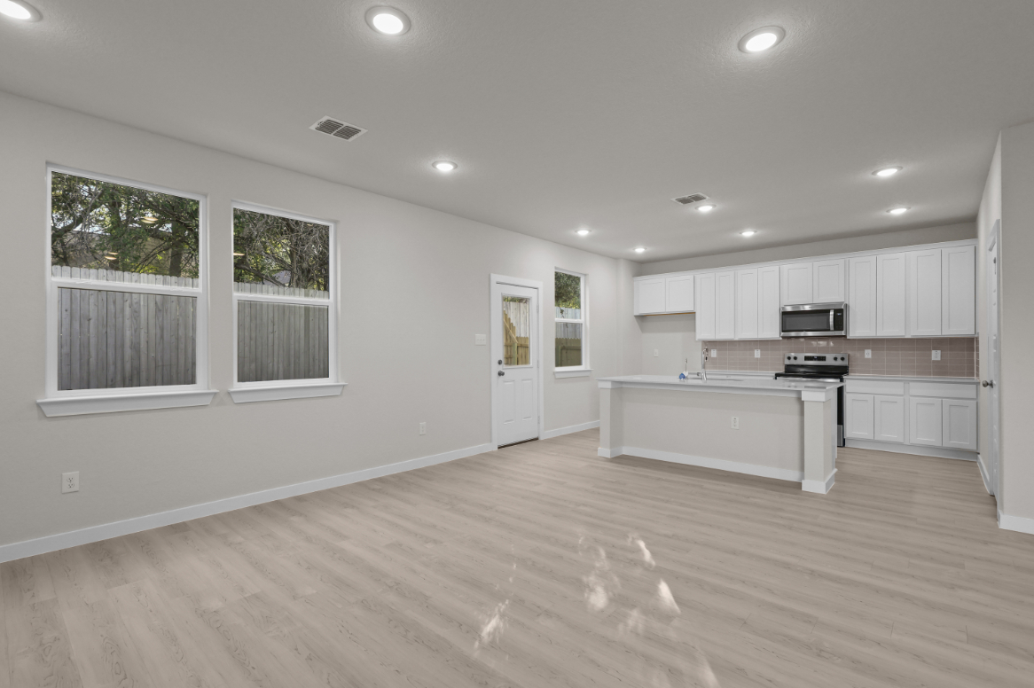 A kitchen with white cabinets.