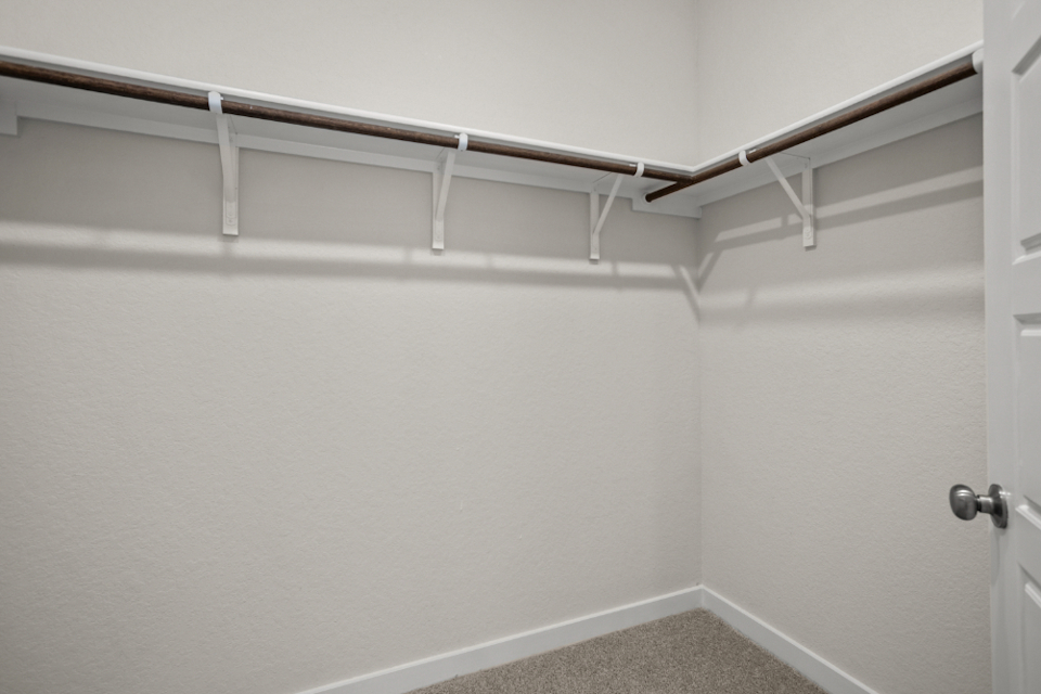 A white wall with a metal railing.