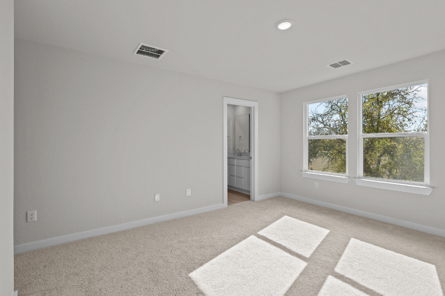 A room with a rug and a window.