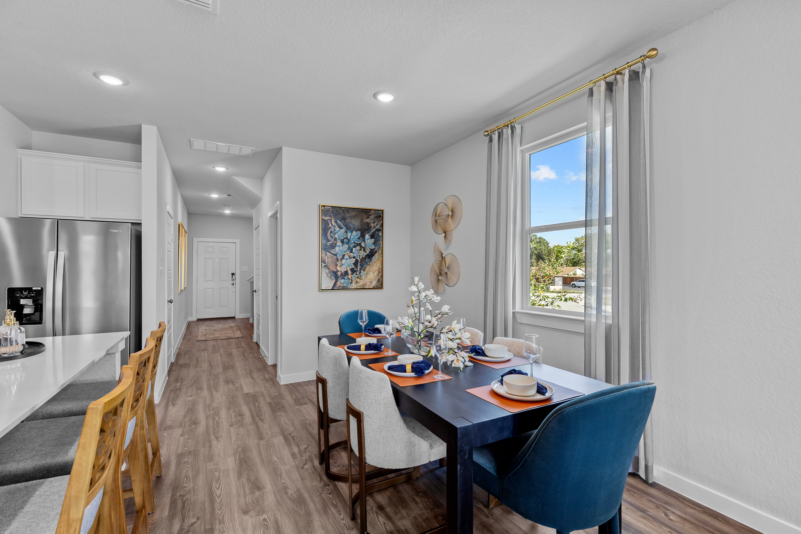 A dining room with a table and chairs.