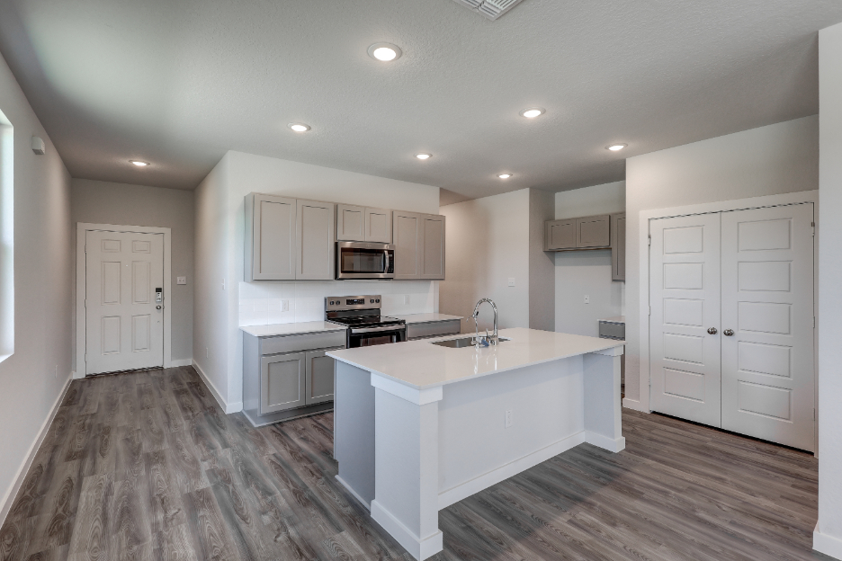 A kitchen with white cabinets.