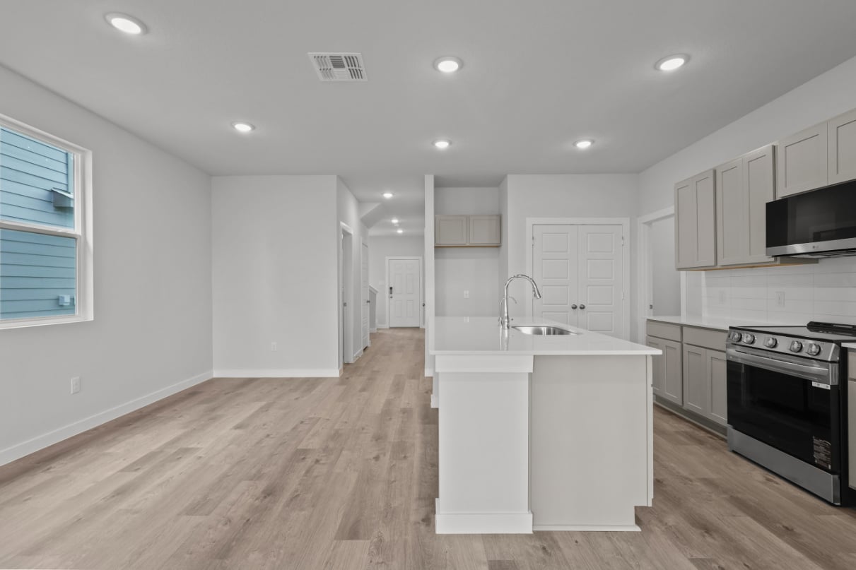 A kitchen with white cabinets.