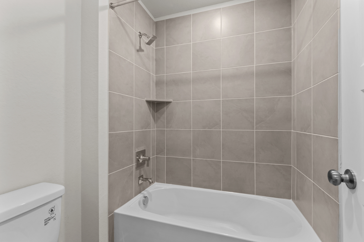 A bathtub in a bathroom.