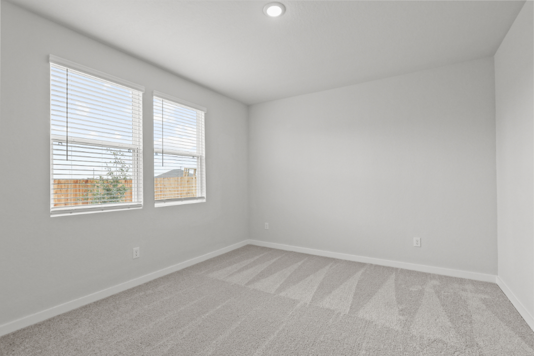 A room with a window and a tile floor.