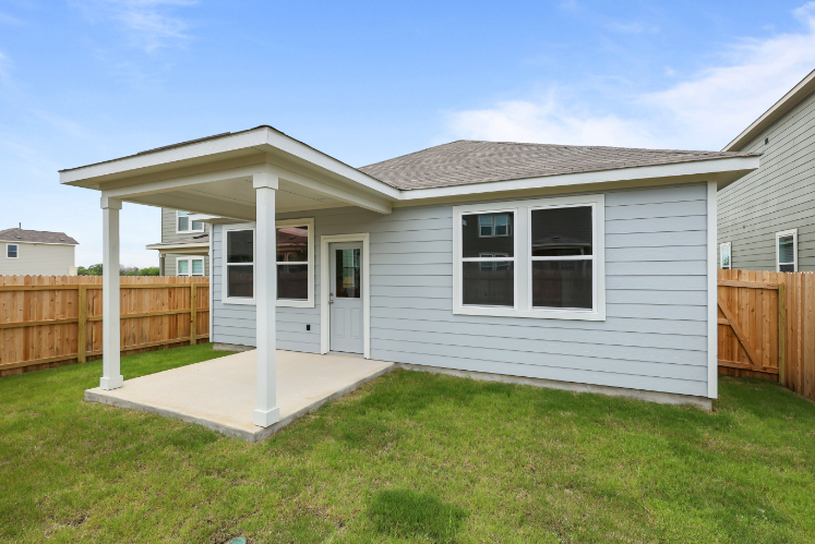 A house with a fence and a yard.