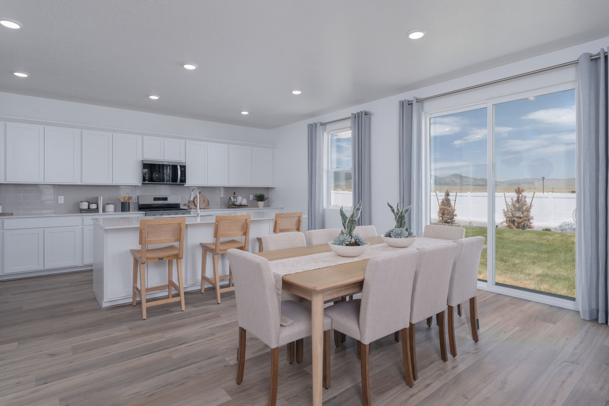 A kitchen with a dining table and chairs.