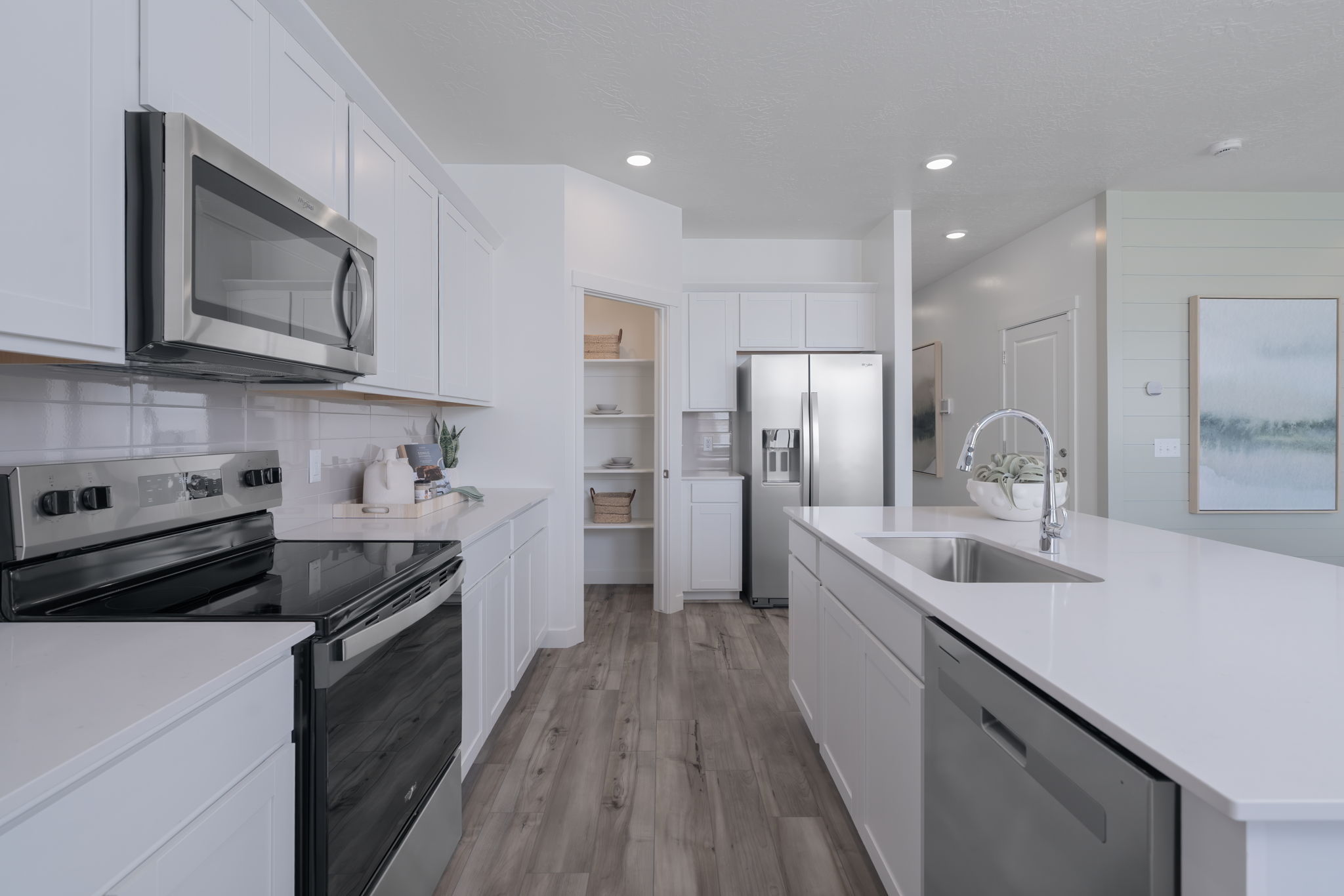 A kitchen with white cabinets.