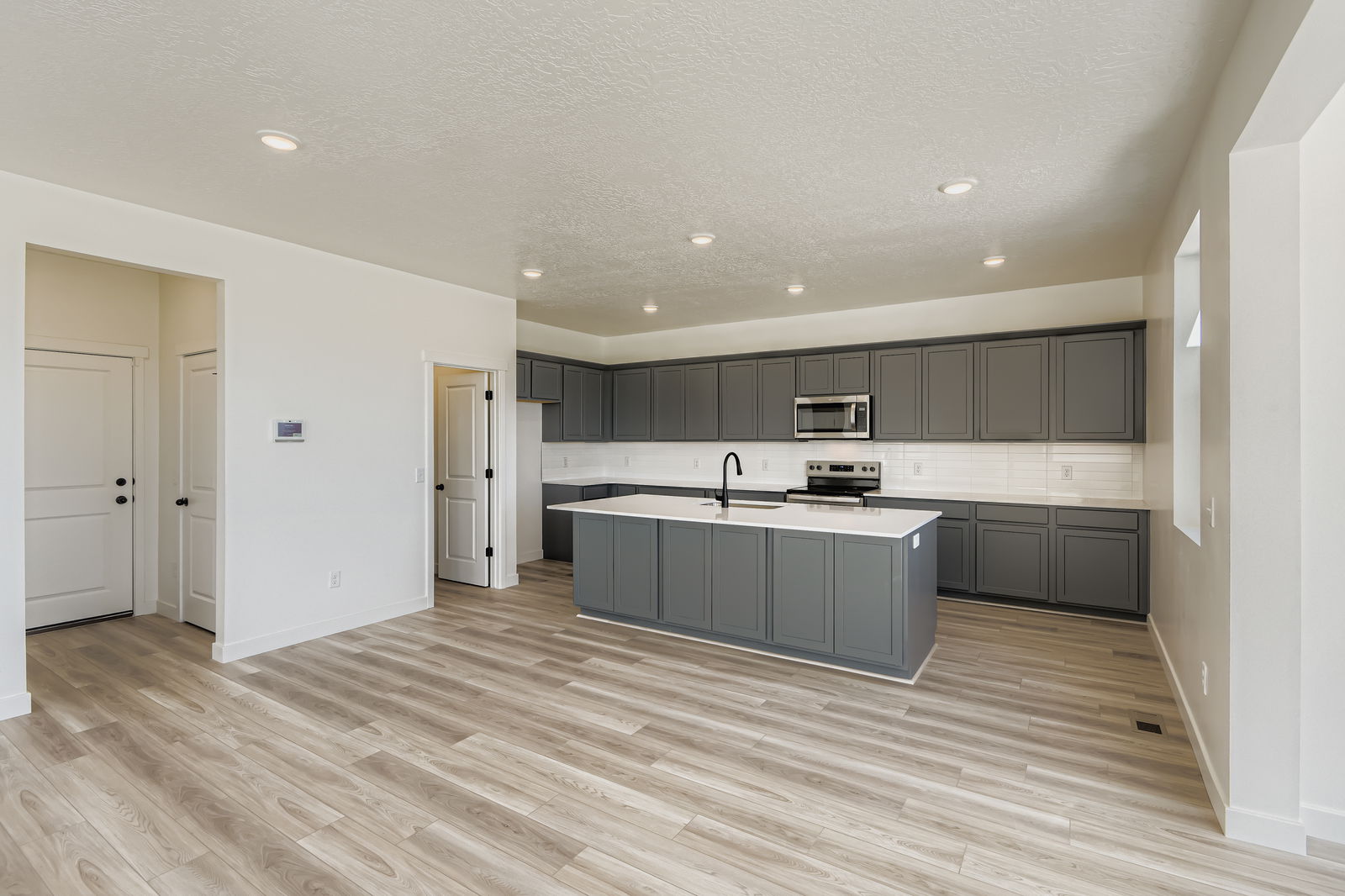 A kitchen with black cabinets.