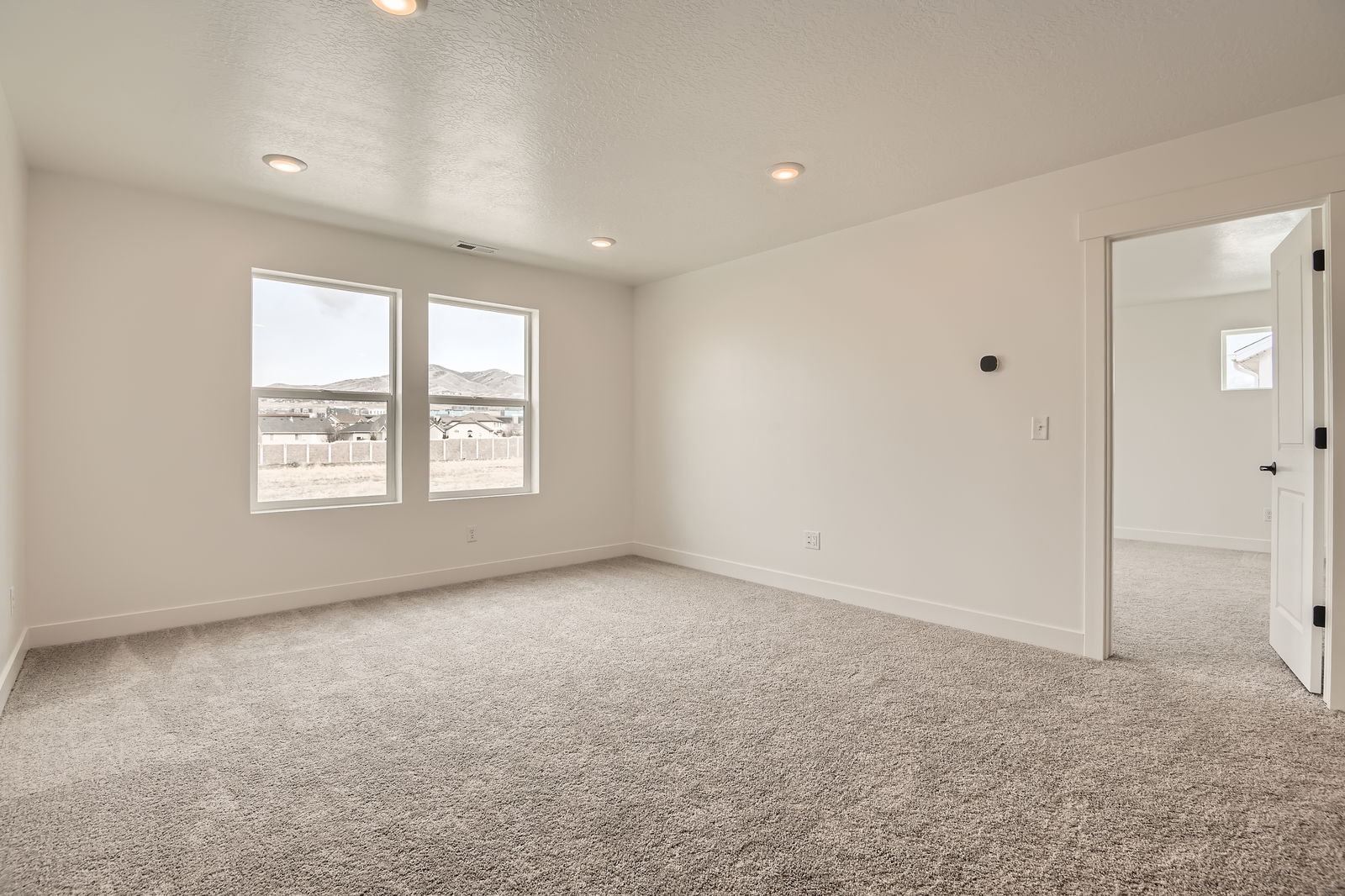 A room with a window and a door.