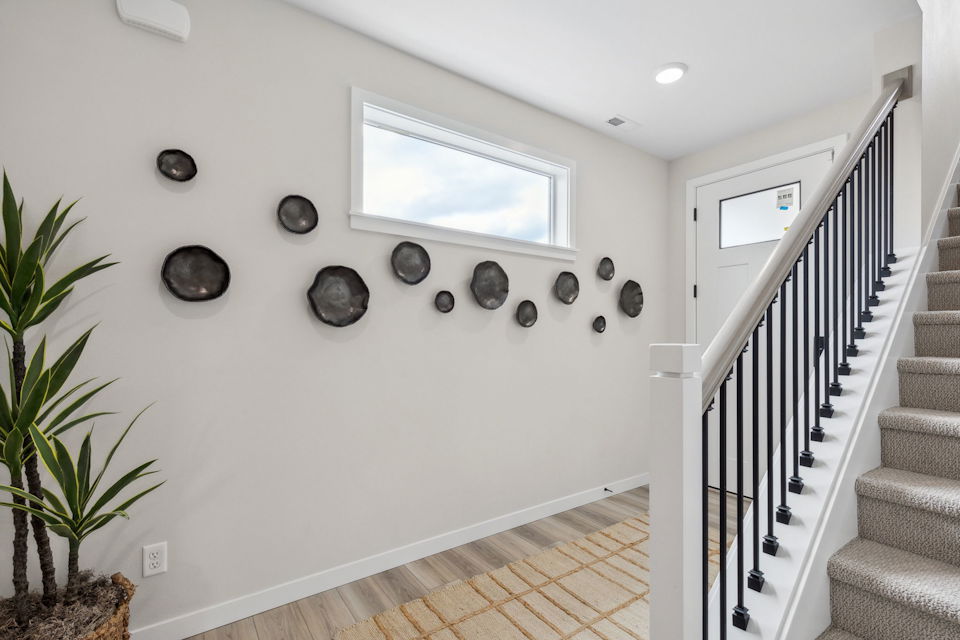 A staircase with a white wall.